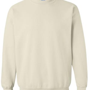 May include: A cream-colored sweatshirt with a crew neck and long sleeves. The garment has ribbed cuffs and a ribbed hem. The fabric appears to be a soft, comfortable material. The sweatshirt is a solid color, suitable for casual wear.