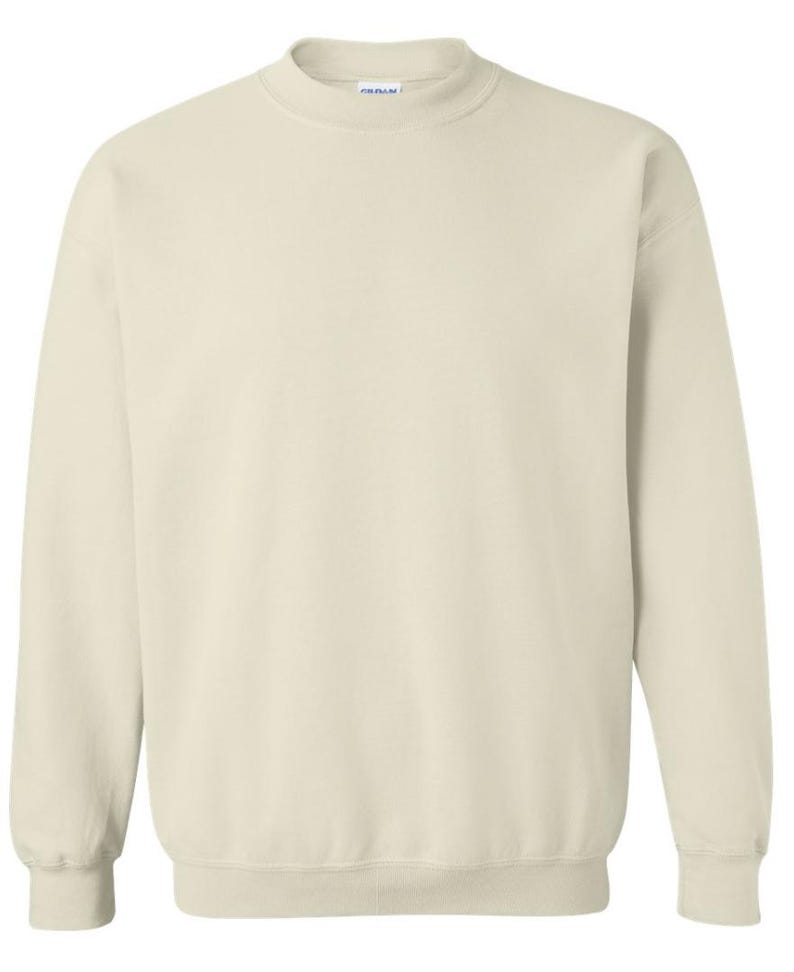 May include: A cream-colored sweatshirt with a crew neck and long sleeves. The garment has ribbed cuffs and a ribbed hem. The fabric appears to be a soft, comfortable material. The sweatshirt is a solid color, suitable for casual wear.