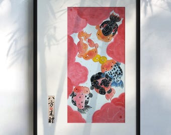 May include: Framed artwork featuring a watercolor painting of goldfish. The fish are in shades of orange, black, and white, set against a backdrop of red cloud-like shapes. Gold coins are also depicted. The frame is black, and the artwork is mounted on a white background.