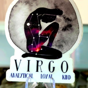 May include: A sticker featuring a black silhouette of a person in a seated position, with a galaxy design within the body. The background is a gray watercolor moon. The word "VIRGO" is at the bottom, with "ANALYTICAL LOYAL KIND" below.
