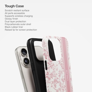 May include: A pink and white floral phone case with a black protective layer and a raised lip for screen protection. The case has the word "CHLOE" printed on the side.