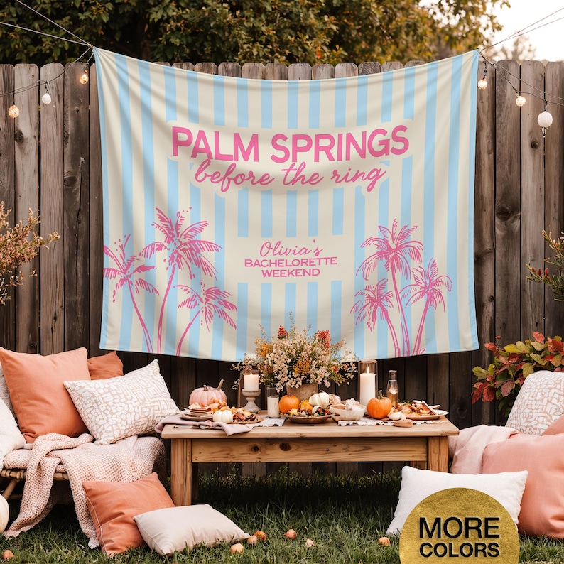 May include: A light blue and cream striped banner with pink text that reads "PALM SPRINGS before the ring" and "Olivia's BACHELORETTE WEEKEND". Pink palm tree graphics are also featured. The banner is hanging outdoors.