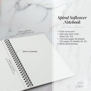 May include: Open spiral softcover notebook with lined pages. The notebook is white with a dark grey back cover and metal spiral binding. It measures 8 inches in height, 6 inches in width, and 0.6 inches in depth. The text on the image says "Spiral Softcover Notebook".