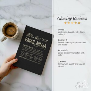 May include: A black notebook with the text "EMAIL NINJA" and "Chris Miller" in silver. The notebook includes icons and phrases like "100% Productivity" and "Caffeine". A cup of coffee sits to the left.