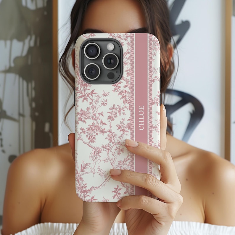 May include: A white and pink floral phone case with a pink stripe and the name "CHLOE" printed on the stripe.