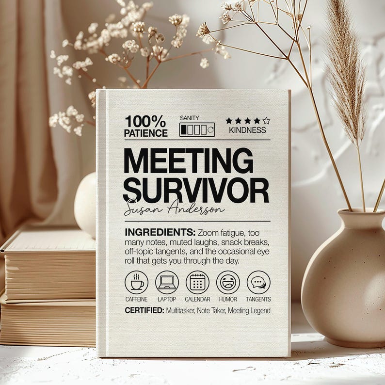 May include: A light-colored book with the text "MEETING SURVIVOR" and the name "Susan Anderson". The book includes the ingredients for surviving meetings: Zoom fatigue, notes, laughs, breaks, tangents, and eye rolls. It also has icons for caffeine, laptop, calendar, humor, and tangents.
