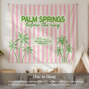 May include: A pink and white striped tapestry with the text "PALM SPRINGS before the ring" in green. The tapestry also features green palm tree illustrations and the text "Olivia's BACHELORETTE WEEKEND".