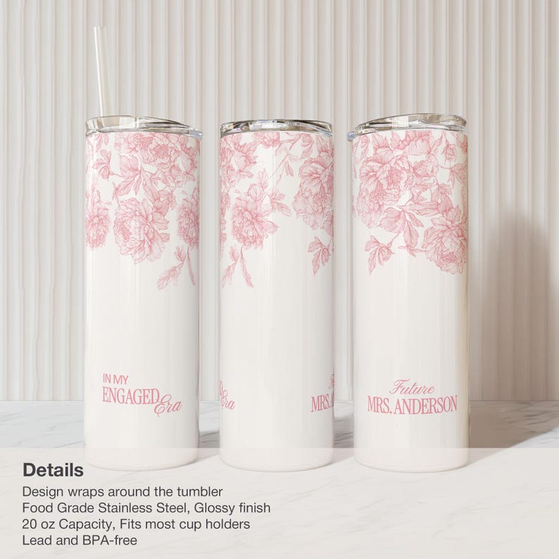 May include: White stainless steel tumblers with pink floral designs. One tumbler reads "In My Engaged Era," another "Mrs," and the third "Future Mrs. Anderson." Each tumbler has a silver lid and a clear straw.