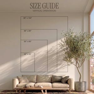 May include: A wall art size guide with the text "SIZE GUIDE VERTICAL ORIENTATION". The guide shows four rectangular sizes: 88" x 104", 68" x 80", 50" x 60", and 26" x 36". The image is in a living room setting with a sofa and a potted tree.