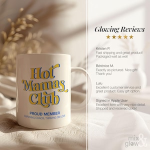 May include: A white ceramic mug with the text "Hot Mamas Club" in yellow and blue lettering. Below the main text, it reads "Proud Member, Surviving Chaos, Thriving on Love". The mug has a curved handle.