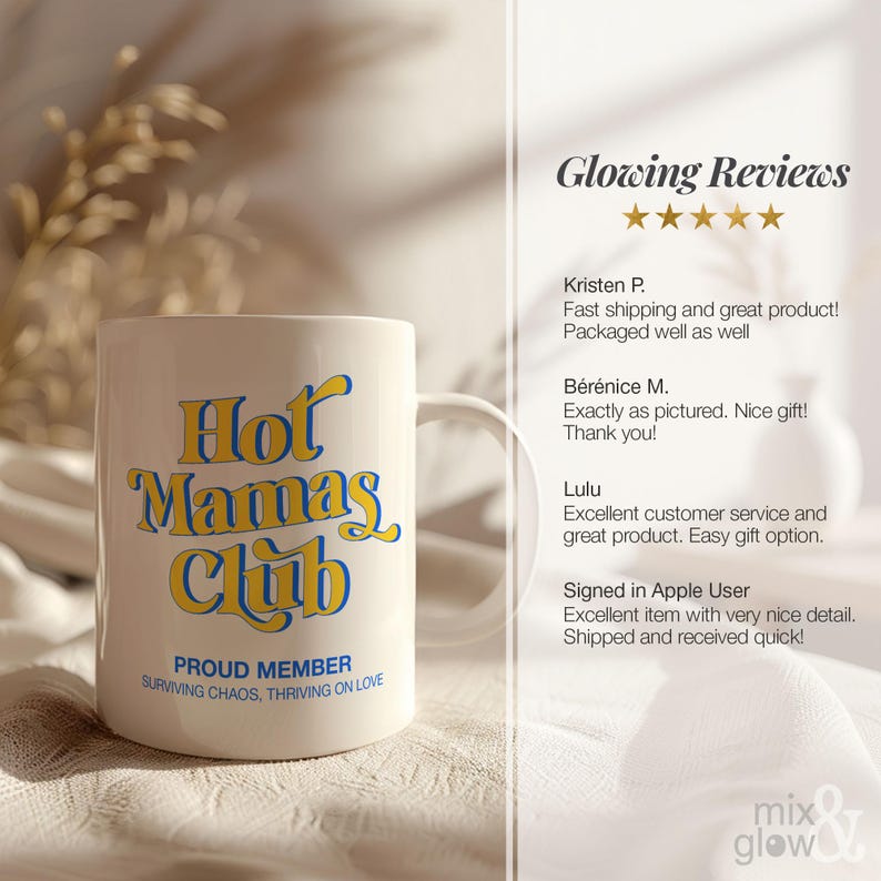 May include: A white ceramic mug with the text "Hot Mamas Club" in yellow and blue lettering. Below the main text, it reads "Proud Member, Surviving Chaos, Thriving on Love". The mug has a curved handle.
