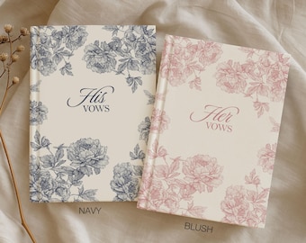 May include: Two hardcover vow books, one navy and one blush, with floral designs. The navy book reads "His Vows" and the blush book reads "Her Vows". The books are cream-colored with floral corner accents. The bottom of the image reads "MORE COLORS AVAILABLE".