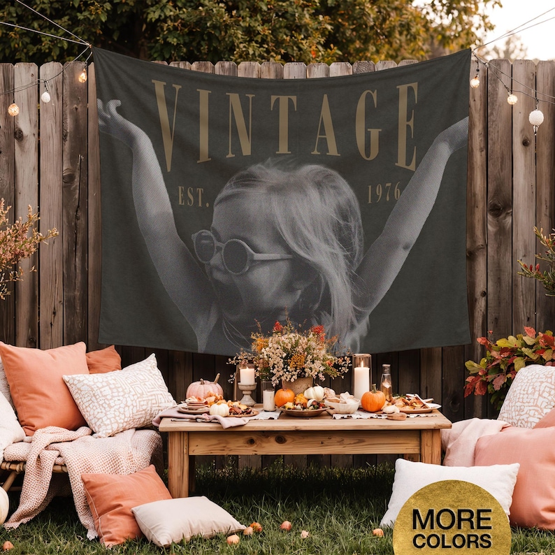 May include: A rectangular wall tapestry featuring a black and white photograph of a child with arms raised, wearing sunglasses. The text VINTAGE is printed in large gold letters at the top, with EST. 1976 centered below the word in smaller gold font.