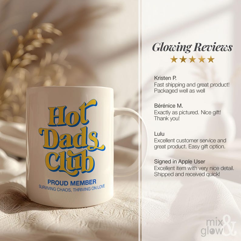 May include: A white ceramic mug with the text "Hot Dads Club" in yellow and blue lettering. The mug also has the text "PROUD MEMBER" and "SURVIVING CHAOS, THRIVING ON LOVE".