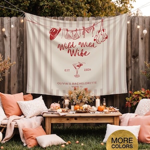 Puede incluir: Una pancarta a rayas beige y blancas con el texto "Wild Wild Wife" y "Olivia's Bachelorette Miami, FL" en rojo. La pancarta tiene ilustraciones de un sombrero de vaquero, lencer&iacute;a y botas. Una mesa de madera est&aacute; puesta con calabazas, flores y comida.