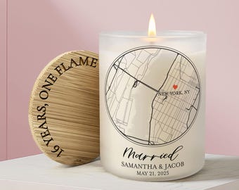 May include: A frosted glass candle with a lit wick, featuring a circular black map graphic of New York, NY with a red heart, the text Married, Samantha & Jacob, May 21, 2025, and a bamboo lid engraved with the text 16 YEARS, ONE FLAME.