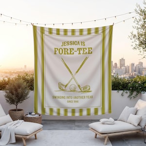 May include: A white golf-themed banner with green stripes and text. The banner reads "JESSICA IS FORE-TEE" with crossed golf clubs and a golf ball. Additional text says "SWINGING INTO ANOTHER YEAR SINCE 1986".