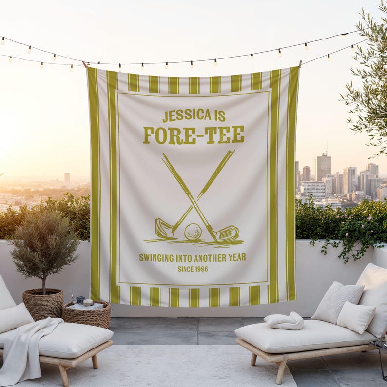 May include: A white golf-themed banner with green stripes and text. The banner reads "JESSICA IS FORE-TEE" with crossed golf clubs and a golf ball. Additional text says "SWINGING INTO ANOTHER YEAR SINCE 1986".