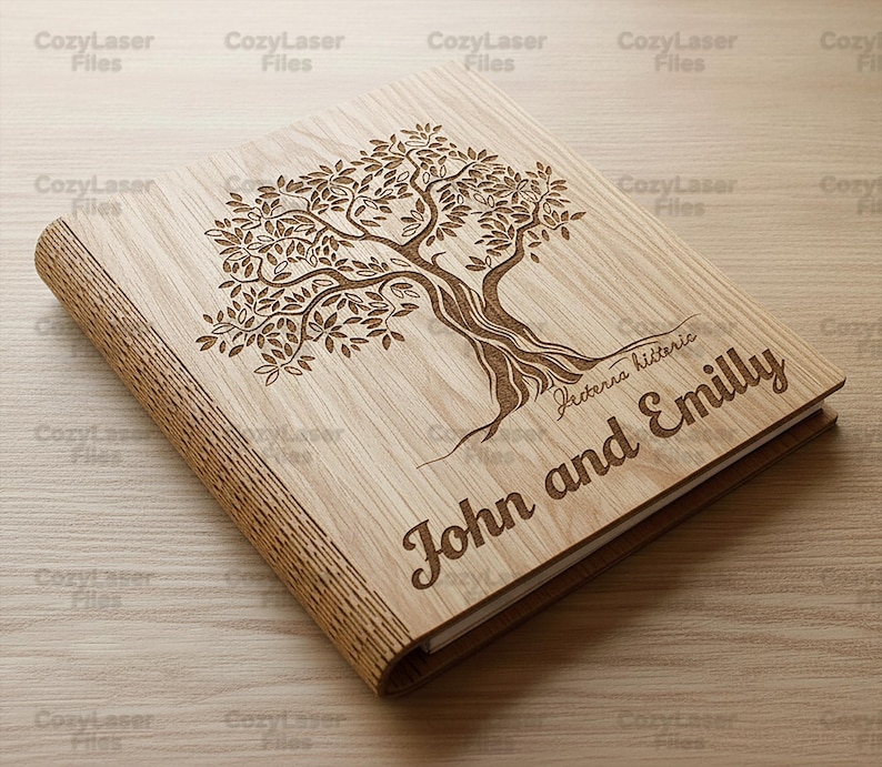 May include: A wooden photo album with a laser-engraved tree design on the cover. The album is light brown with the names "John and Emilly" and the text "Fecterna hitteric" engraved on the cover.