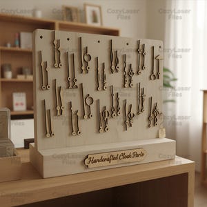 May include: A wooden display featuring various laser-cut clock hands in different styles. The display is light-colored with dark brown clock hands. The base of the display has the text "Handcrafted Clock Parts".