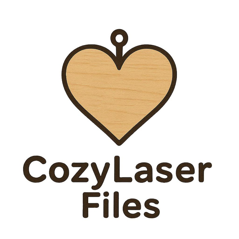 May include: A wooden heart-shaped pendant with a dark brown outline and a small loop at the top. The heart has a light brown wood grain texture. Below the heart is the text "CozyLaser Files" in dark brown.