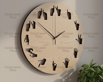 May include: A round wooden wall clock with black hands and cut-out hand gestures representing numbers. The clock has the text "CozyLaser Files" repeated around the perimeter.