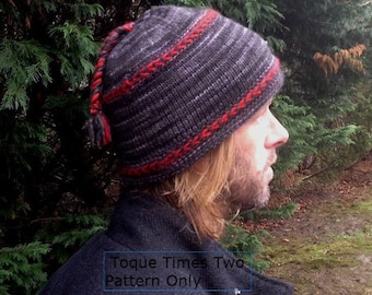 Puede incluir: Un gorro de punto negro y rojo con una trenza larga que cuelga por la espalda. El gorro tiene el texto "Toque Times Two Pattern Only" en la parte delantera.