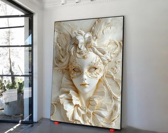 May include: A large, framed wall art piece featuring a sculpted relief of a Venetian mask. The mask is white with gold accents, including the eyes and decorative details. The artwork has a cream-colored background and a black frame.