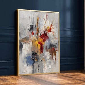 Pode incluir: Pintura abstrata com moldura dourada. A obra apresenta uma superfície texturizada com uma mistura de cores, incluindo vermelho, amarelo, cinza e azul. A composição tem um estilo dinâmico e expressivo.