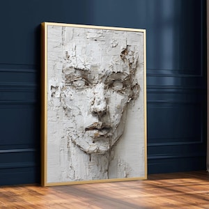 May include: A textured white and brown relief sculpture of a human face in a gold frame. The artwork features a detailed depiction of facial features, with visible brushstrokes and a three-dimensional effect, creating a striking visual impact.