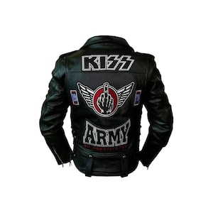 May include: Black leather jacket with the word "KISS" across the upper back. The jacket features patches with the words "ARMY" and "NO SUBSTITUTES". A central patch displays a hand gesture with wings.