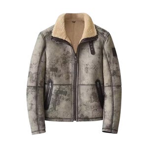 May include: A distressed-look, gray shearling jacket with a cream-colored shearling collar. The jacket features a zip-up front, two zippered pockets, and leather accents. The jacket is a classic outerwear piece.