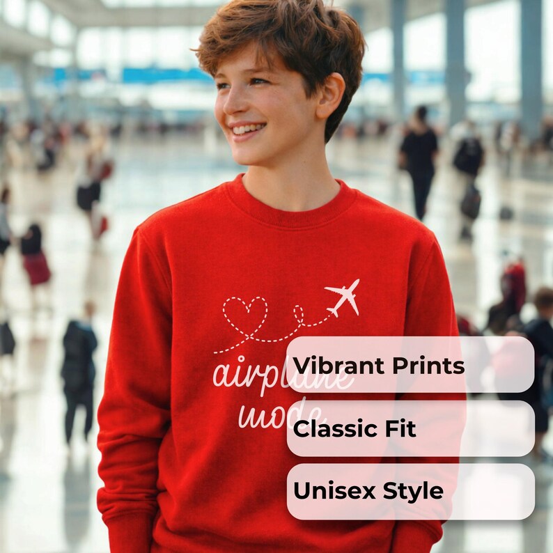 May include: A red crewneck sweatshirt with a white graphic of a heart, airplane, and the words "airplane mode." The sweatshirt also has the words "Vibrant Prints," "Classic Fit," and "Unisex Style" in white text.