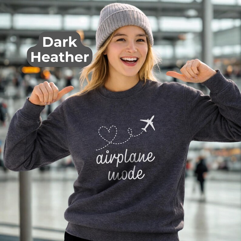 May include: Dark heather gray sweatshirt with the text "airplane mode" and a graphic of a heart and airplane. The sweatshirt is a crew neck style.