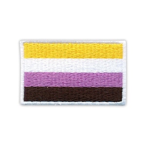 May include: A rectangular embroidered patch displaying the non-binary pride flag. It features horizontal stripes in yellow, white, purple, and brown, with a white border. The colours are vivid and the stitching is detailed.