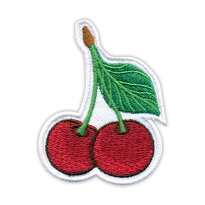 May include: Embroidered patch featuring two red cherries with green stems and a leaf. The patch has a white border. The cherries are a vibrant red color, and the leaf is green with detailed stitching.