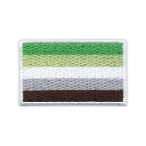 May include: Embroidered patch featuring the aromantic pride flag. The rectangular patch has horizontal stripes in shades of green, light green, white, gray, and brown, with a white border. The patch is designed to be sewn or ironed onto fabric.