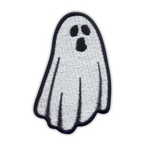 May include: Embroidered patch of a white ghost with a black border. The ghost has two black eyes and a black open mouth. The patch has a textured, stitched design, suitable for Halloween or themed crafts and projects.