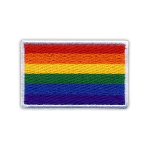 May include: A rainbow pride flag patch with six horizontal stripes in the colors red, orange, yellow, green, blue, and purple. The patch is surrounded by a white border.