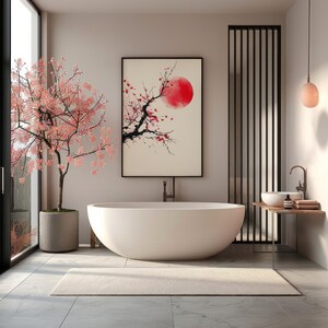 May include: A modern bathroom with a large, white oval bathtub. A framed artwork depicting a red sun and cherry blossoms hangs above the tub. A cherry blossom tree in a concrete pot stands near a large window. A neutral rug is on the floor.