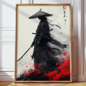 Peut inclure: Impression artistique encadrée d'un samouraï en tenue noire et chapeau de paille, tenant un katana. L'œuvre présente un schéma de couleurs rouge et noir saisissant, avec de la calligraphie japonaise et un sceau rouge en haut à droite.