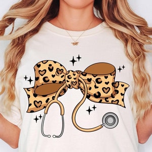 Comfort Colors® Coquette Nurse Stethoscope Bow Shirt, Gift for Nurse, Nurse Bow Shirt, Coquette Nurse Shirt, Leopard Nurse Ribbon Shirt