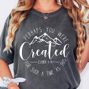 May include: Gray t-shirt with a white graphic that says "Perhaps you were created for such a time as this - Esther 4:14" with a mountain range design.