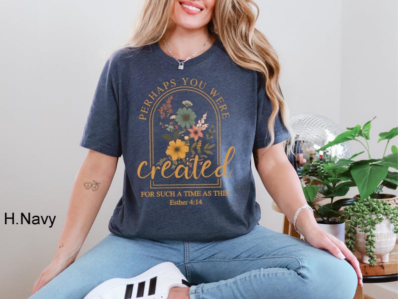 Może przedstawiać: Koszulka w kolorze granatowym z kwiatowym wzorem i tekstem "Perhaps you were created for such a time as this Esther 4:14".