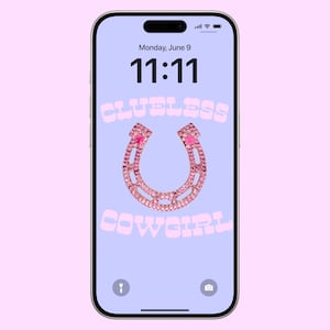 May include: A smartphone screen displaying a pink and white graphic with the text "Clueless Cowgirl" and a pink horseshoe with pink rhinestones. The time on the screen is 11:11.