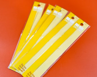 May include: Five packs of yellow beading needles with the text "Bead Smith" and "Big Eye Beading Needle" on the packaging.