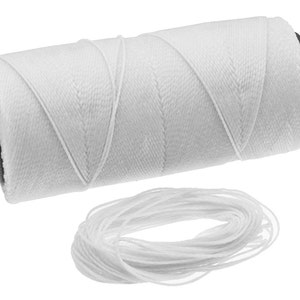 May include: A spool of white waxed thread with a length of thread unwound from the spool.