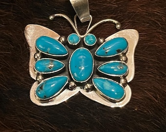 Navajo Darrin Livingston made and signed authentic turquoise and silver butterfly pendant.