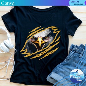 May include: A dark blue t-shirt with a graphic of a bald eagle's head peeking out of a yellow claw mark. The eagle has a fierce expression with sharp eyes and a beak.