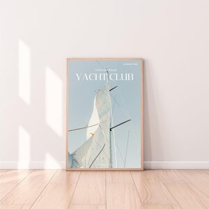 May include: A magazine cover with the title "YACHT CLUB" in white text on a light blue background. The cover features a close-up of a sailboat's sail billowing in the wind.